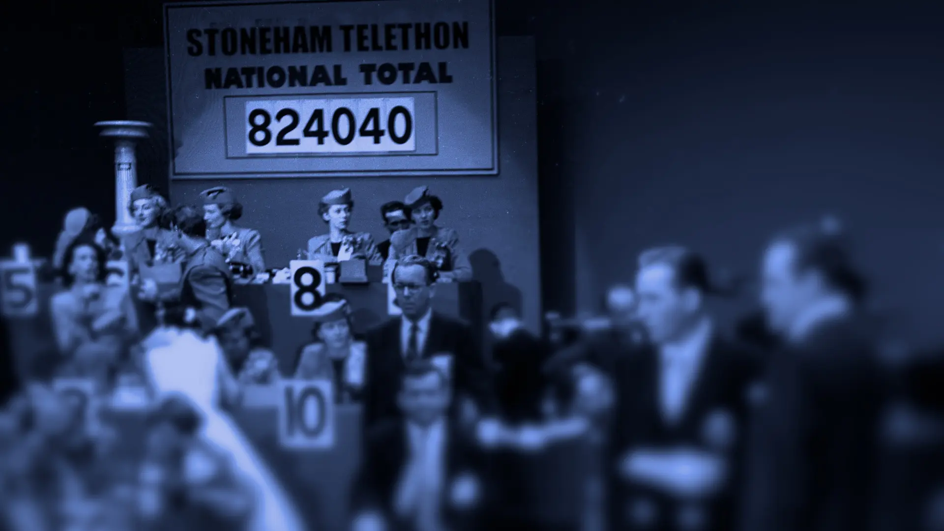 A vintage photo of a telethon fundraiser with people taking phone calls and counting money.