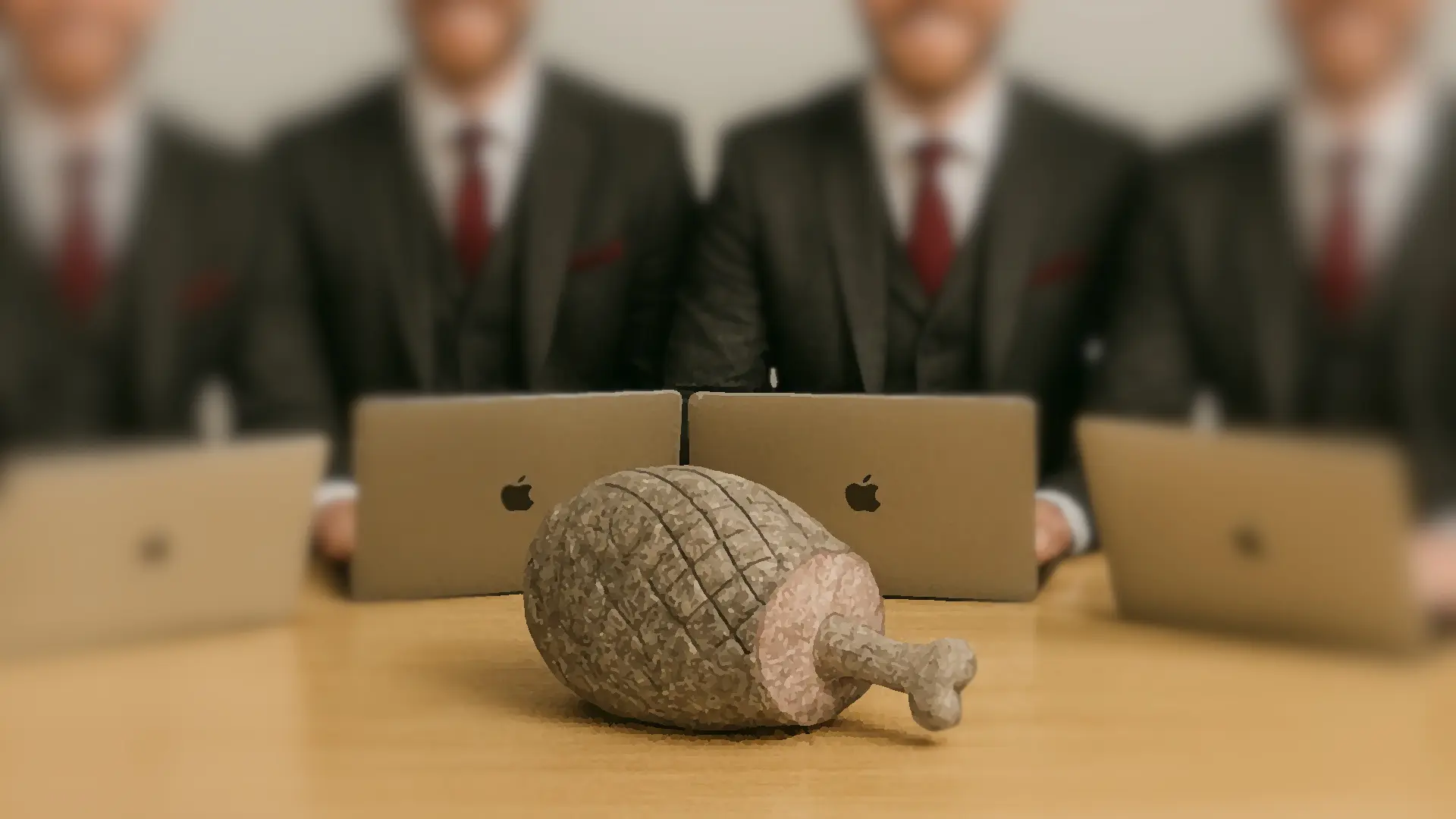 Four identical-looking hipster consultants sit around a table, staring at a ham made out of stone.
