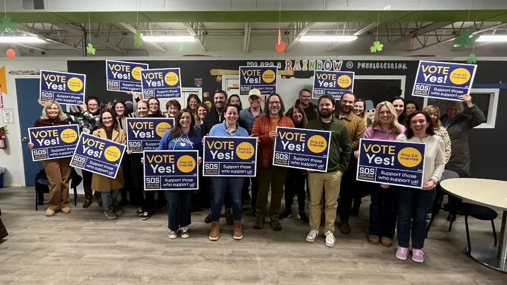 Group photo of Save our Stoneham members holding 'Vote Yes' signs.