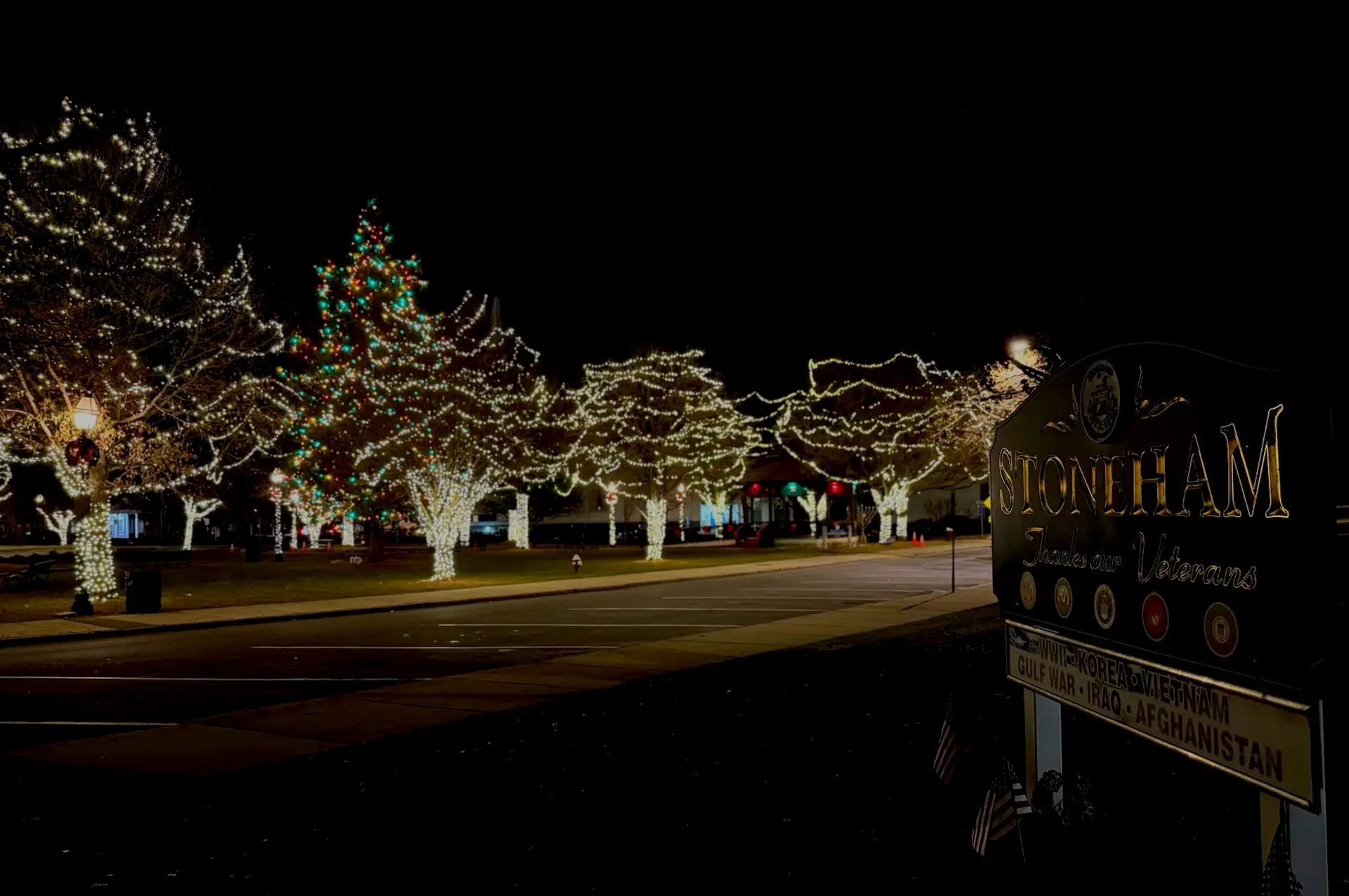Photo of the Stoneham town common at night, adorned with Christmas lights