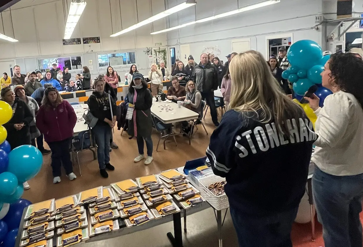 Group photo of Stoneham residents holding 'Vote Yes!' signs